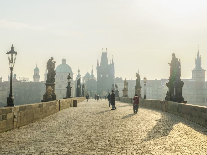 A tranquil morning on Charles Bridge, Prague, showcasing historical architecture under the