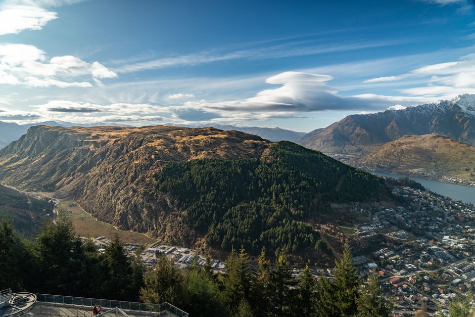 Breathtaking aerial view of Queenstown, New Zealand showcasing lush mountains and vibrant townscape.