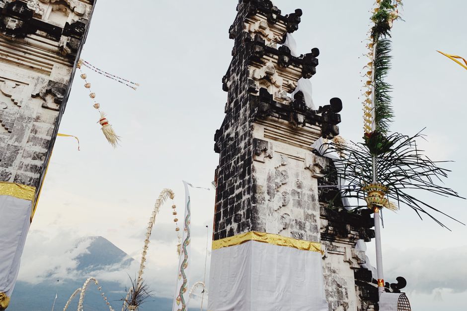 View of traditional Balinese temple gates with scenic Mount Agung in the distance.