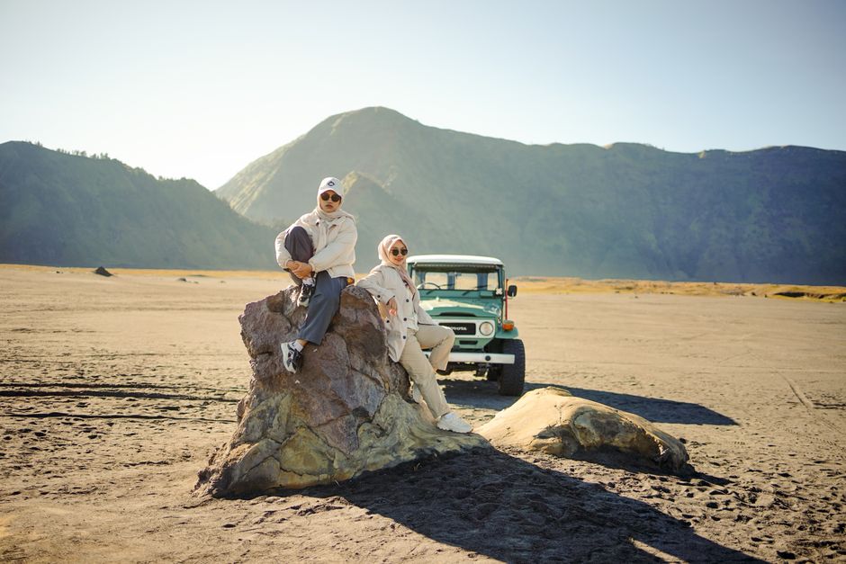 Two women in hijabs enjoying a road trip at Mount Bromo, East Java.