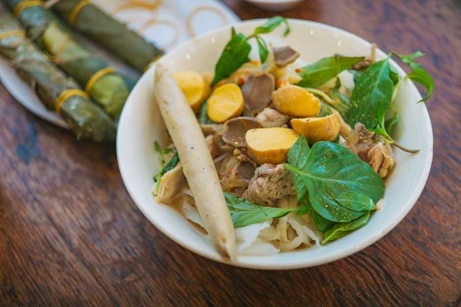 A vibrant noodle soup with herbs and vegetables, perfect for a flavorful meal.